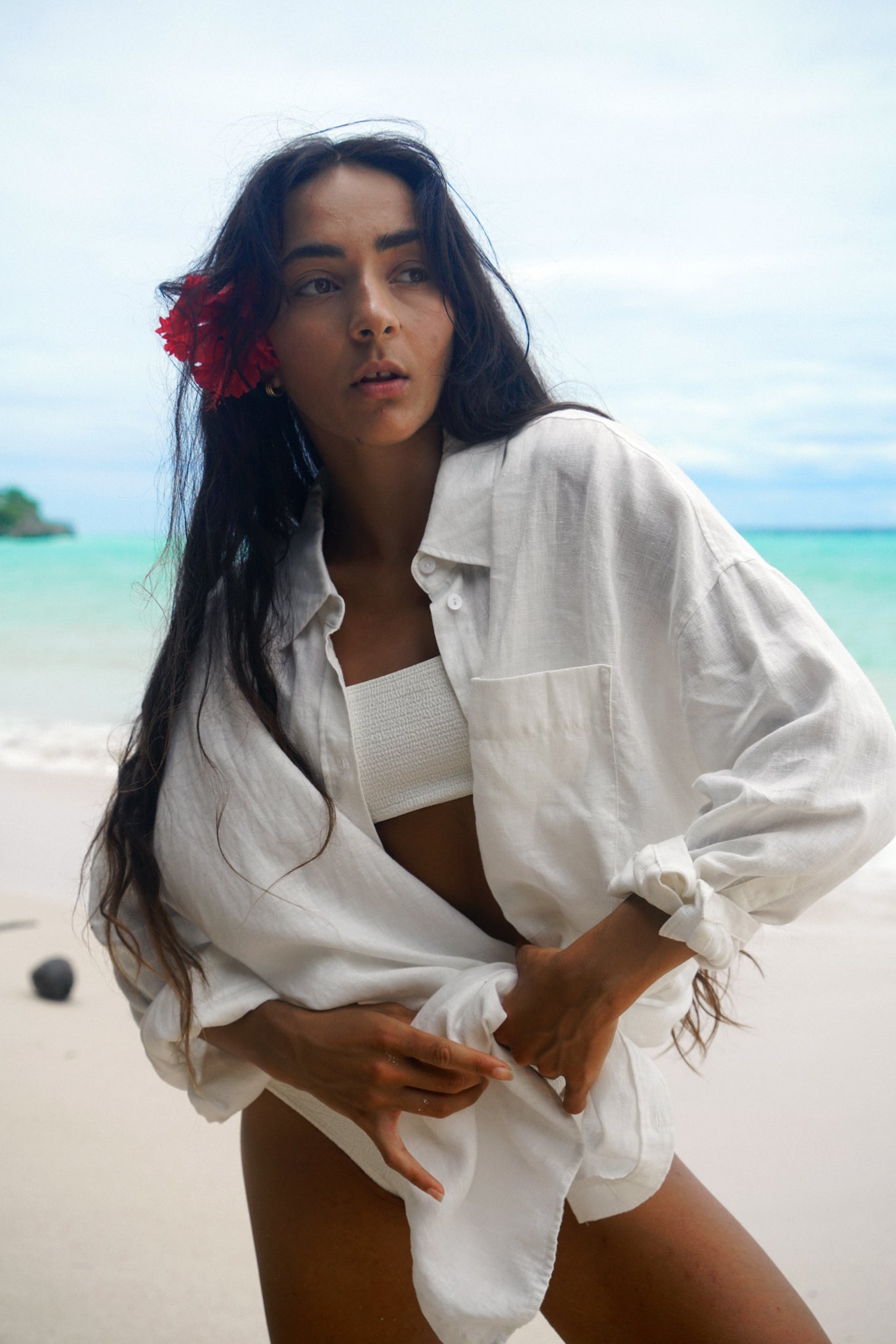 Lilly Pilly Collection Kirra shirt made from European linen in Ivory standing on the beach