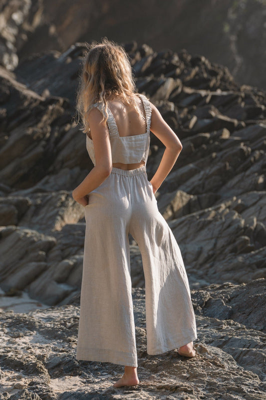 Lilly Pilly Collection European linen Keely jumpsuit in Oatmeal back view walking away